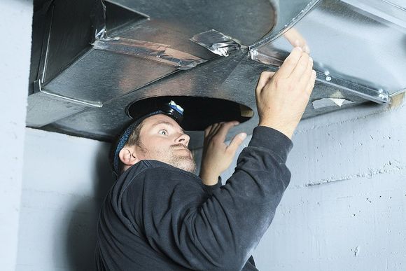 a man inspecting a clients air conditioning duct system for cleanliness in tempe