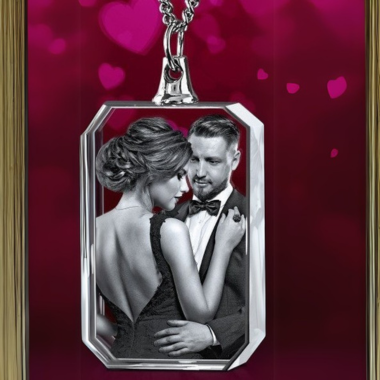 Silver necklace pendant with a black and white photo of a couple embracing.