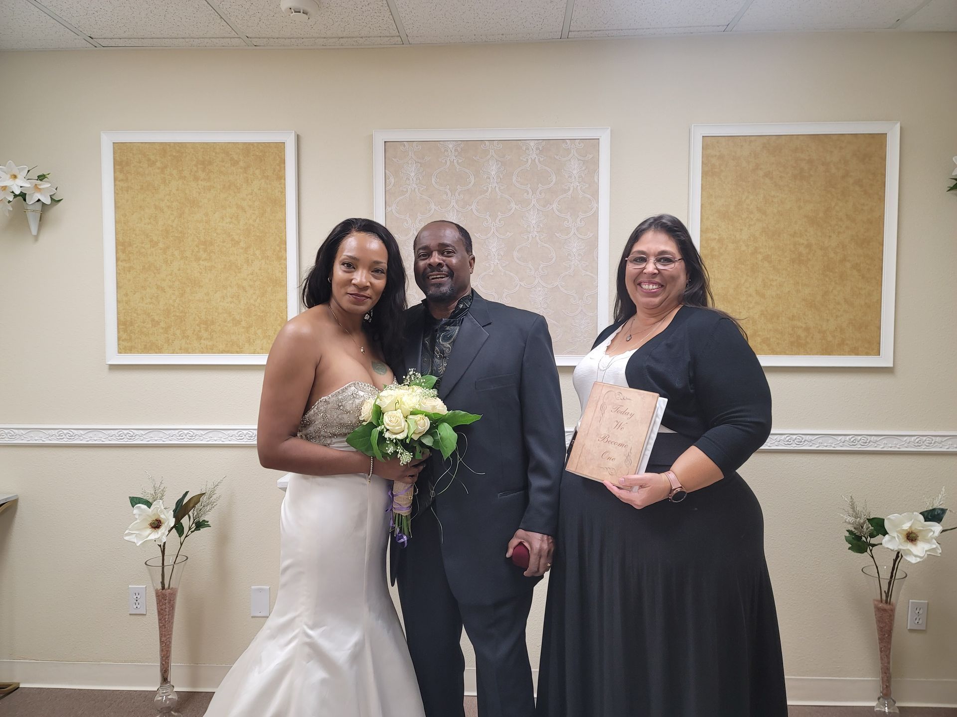 A newly married couple in the Elopement Chapel poses for a photo with Rev. Jennifer after their ceremony