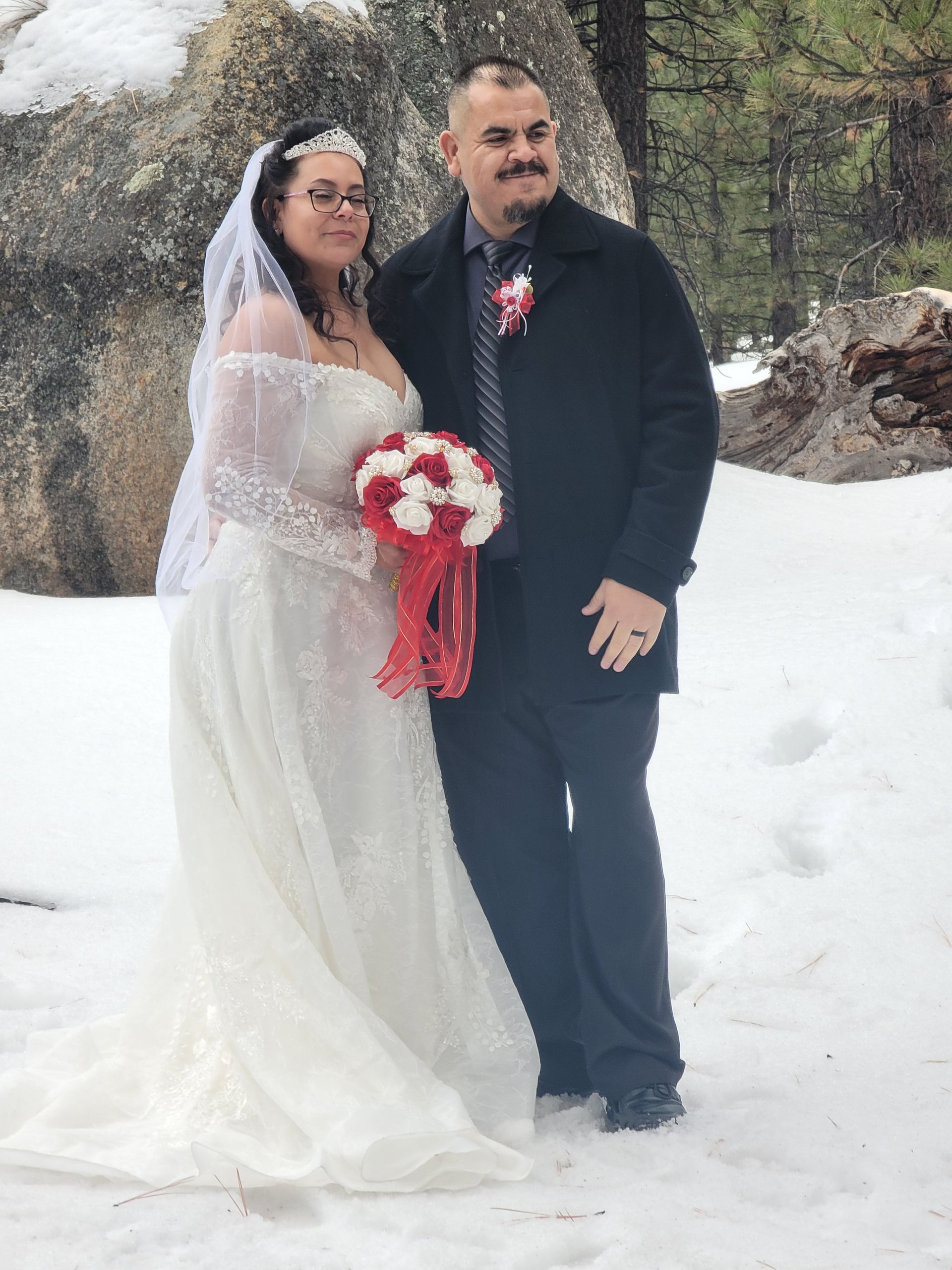 Winter Wonderland Wedding in the Big Bear Mountain with Bride holding a red and white bouquet