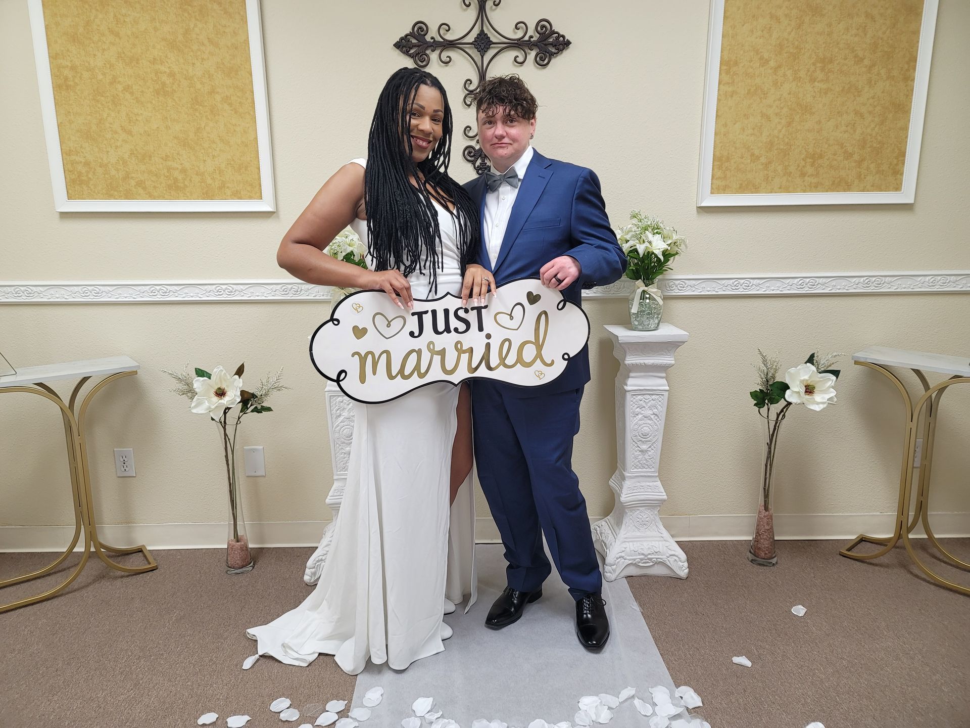 A newly married couple holding the Just Married sign in the Elopement Chapel in Rancho Mirage