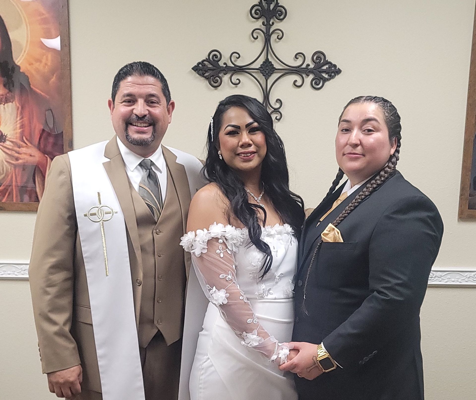 Rev. Steve takes a photo with this couple in front of a cross after a religious ceremony in Rancho Mirage, CA