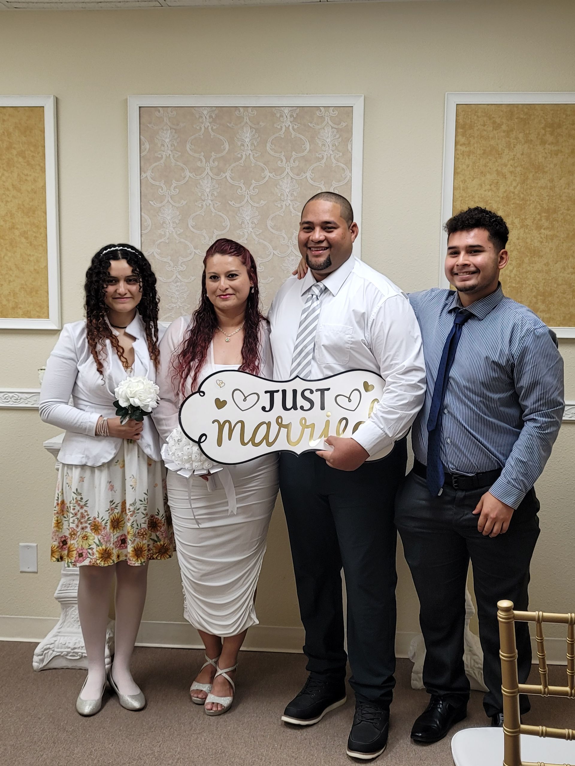 Newlyweds with two people, posing with