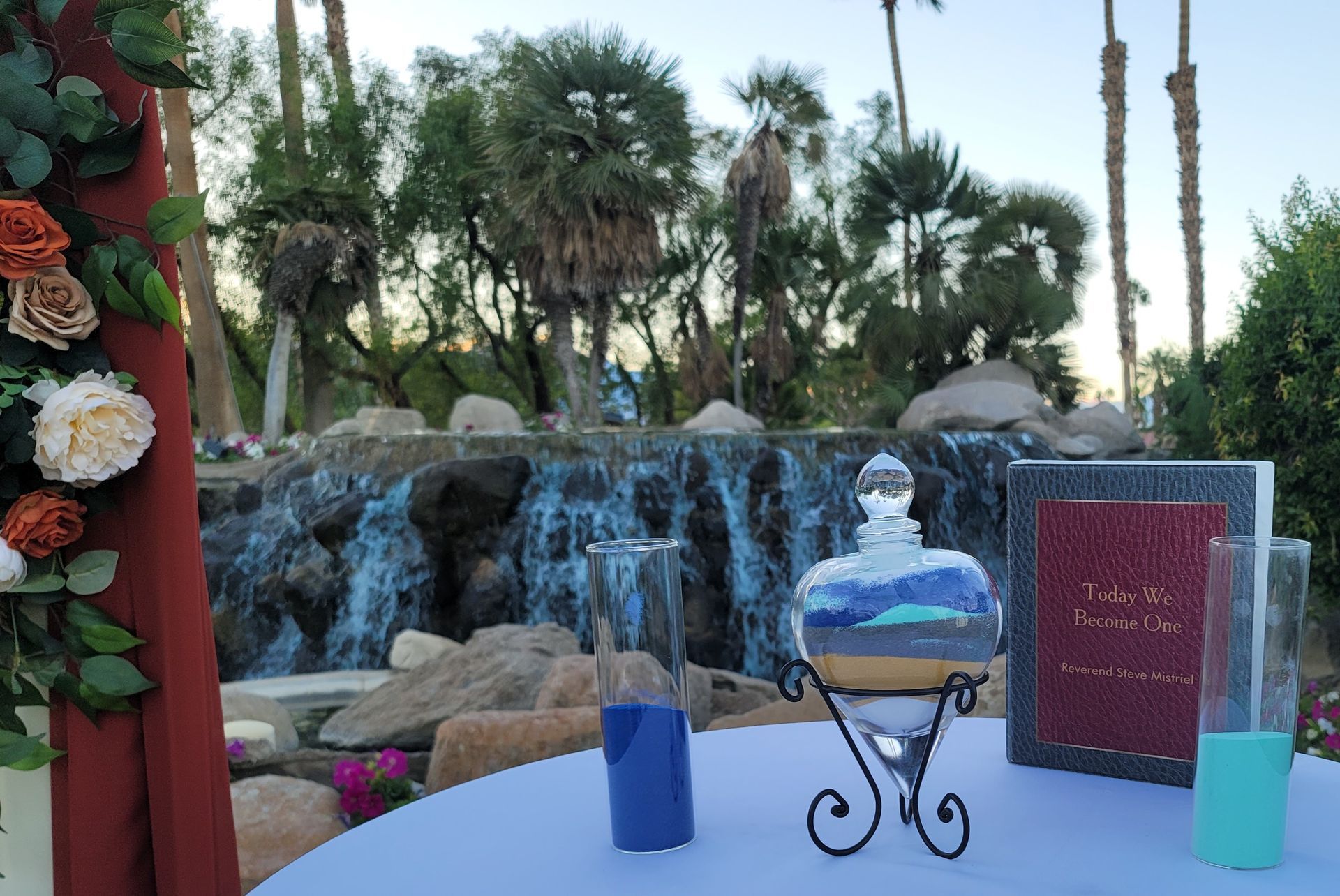 Wedding sand ceremony setup with waterfall backdrop.