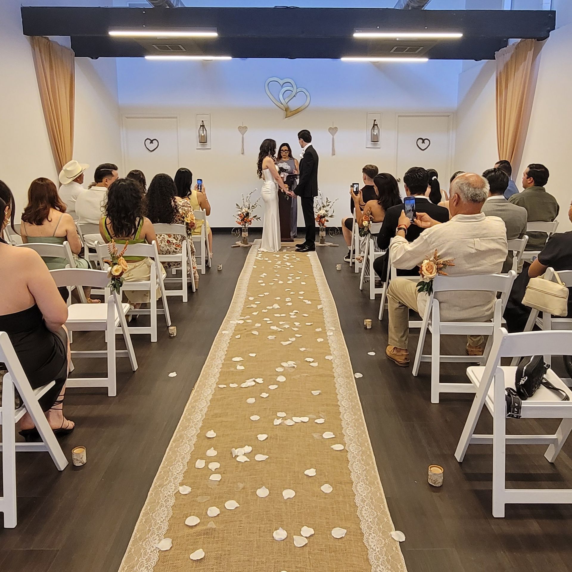 Couple's wedding ceremony with a guests at the Today We Become One Wedding and Event Chapel in Palm Desert, CA