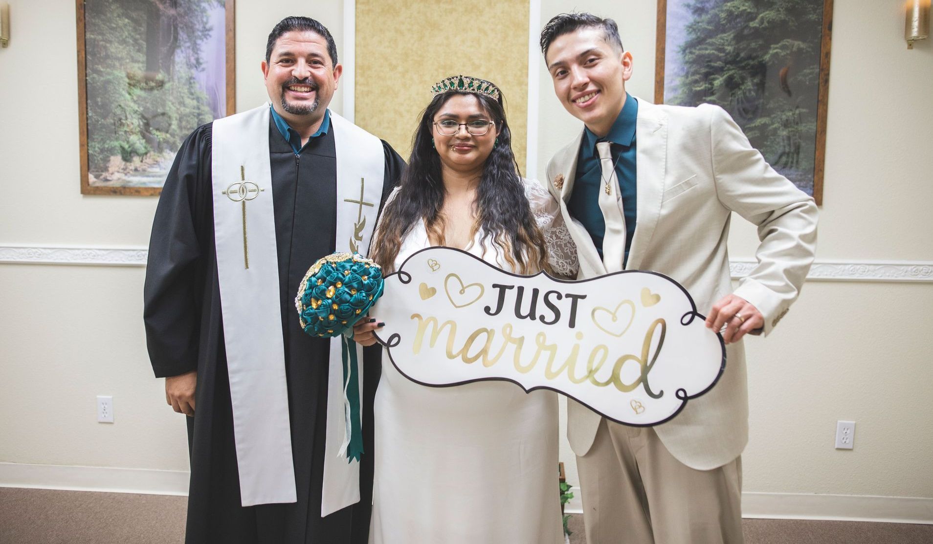 Couple holding the Just Married sign after their ceremony of Holy Matrimony in Rancho Mirage, CA officiated by Rev Steve