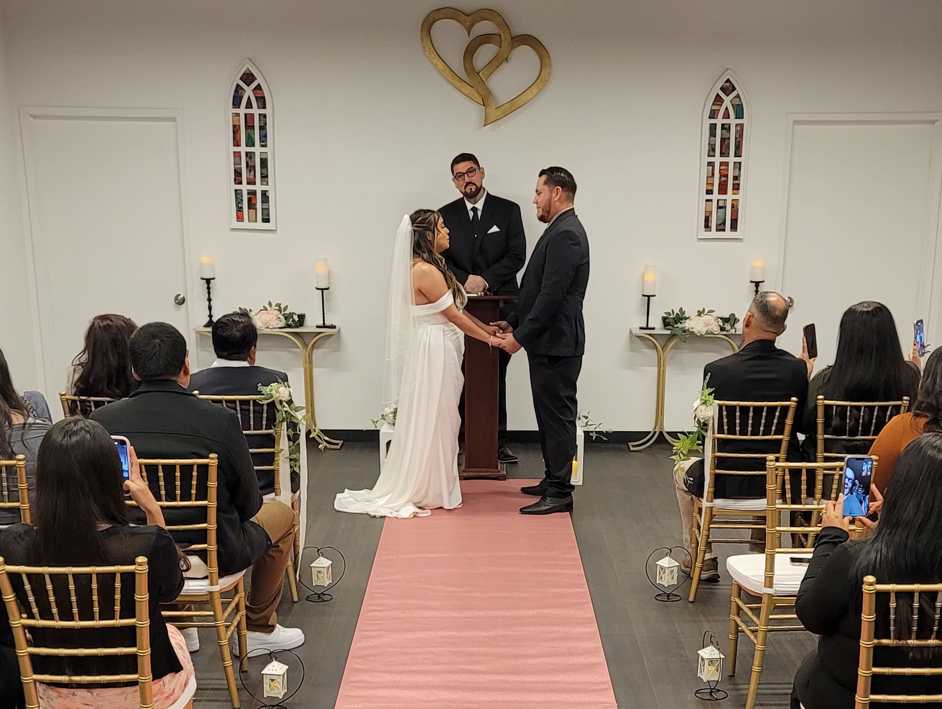 Pink and White Theme Wedding ceremony with guests at the Today We Become One Wedding and Event Chapel in Palm Desert, CA