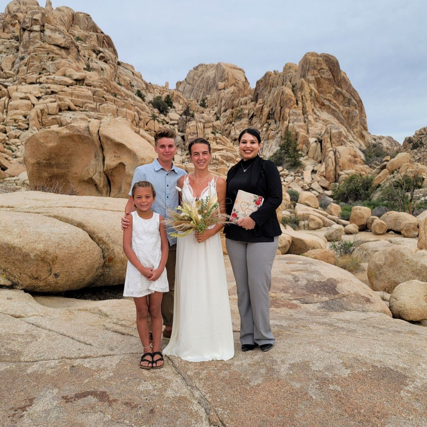 Rev. Zamora in Joshua Tree National Park with a couple just joined in marriage