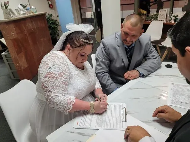 Bride signing her marriage certificate