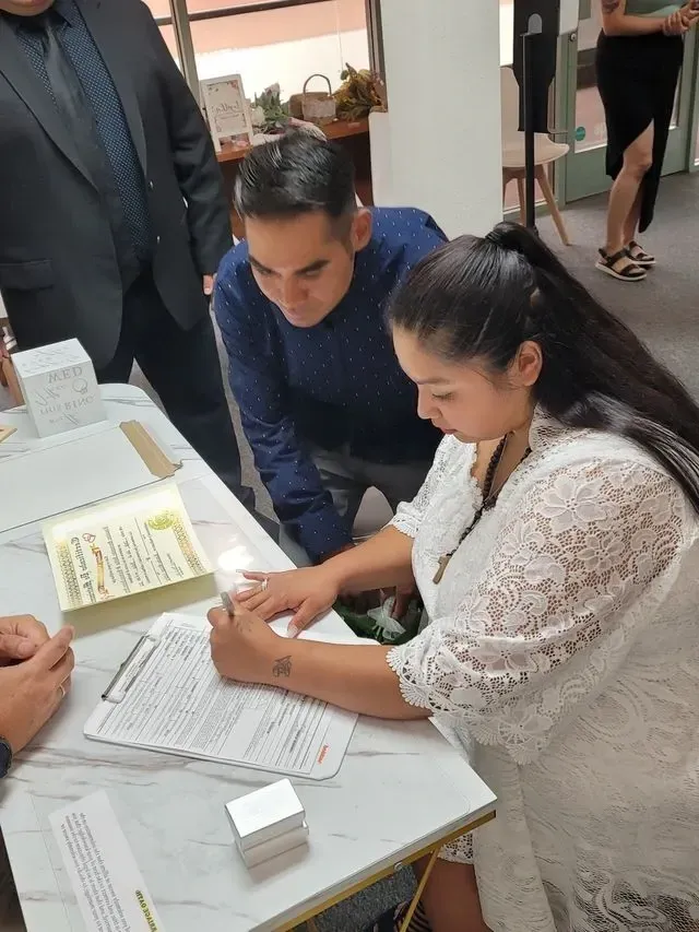 Bride signing a marriage certificate