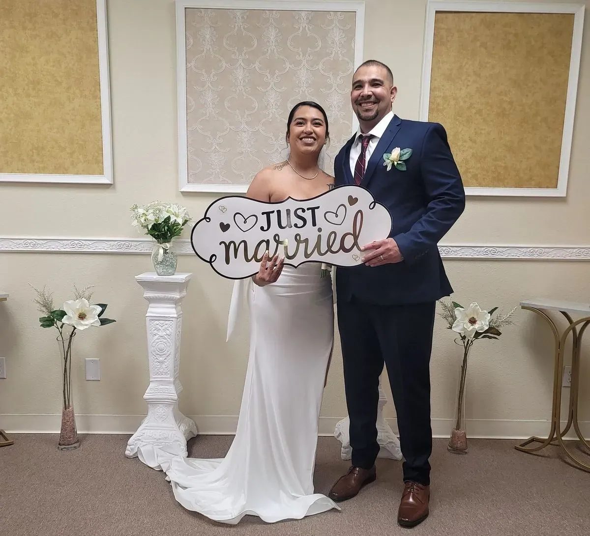 Couple holding a Just Married Sign in the Today We Become One Elopement Chapel in Rancho Mirage, CA