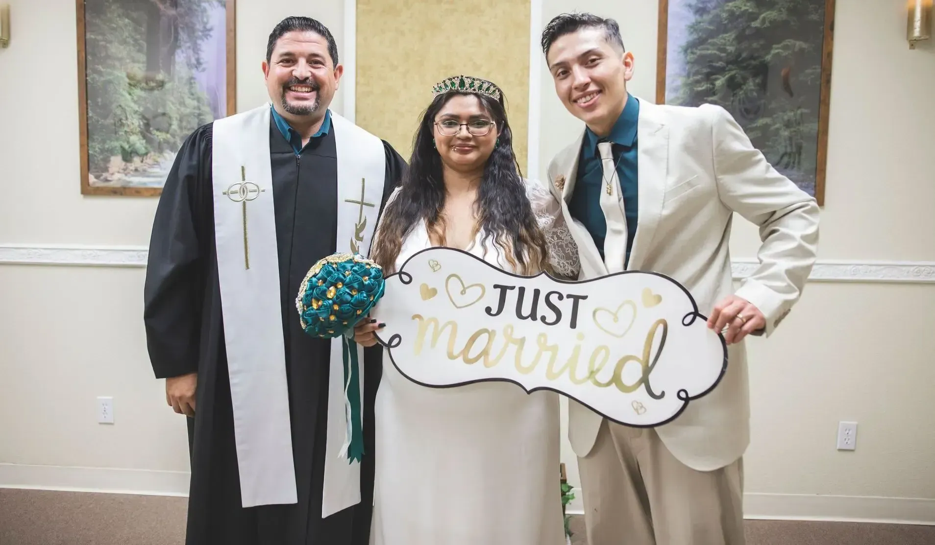Couple holding the Just Married sign after their ceremony of Holy Matrimony in Rancho Mirage, CA officiated by Rev Steve
