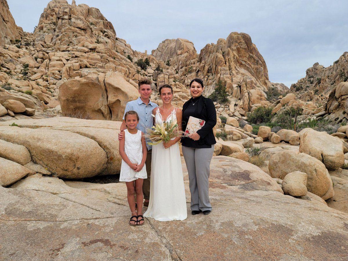 Rev. Zamora in Joshua Tree National Park to wed this couple and take a photo with a guest