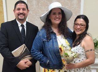 Rev. Steve poses for a photo with a newly married couple in the Elopement Chapel in Rancho Mirage, CA