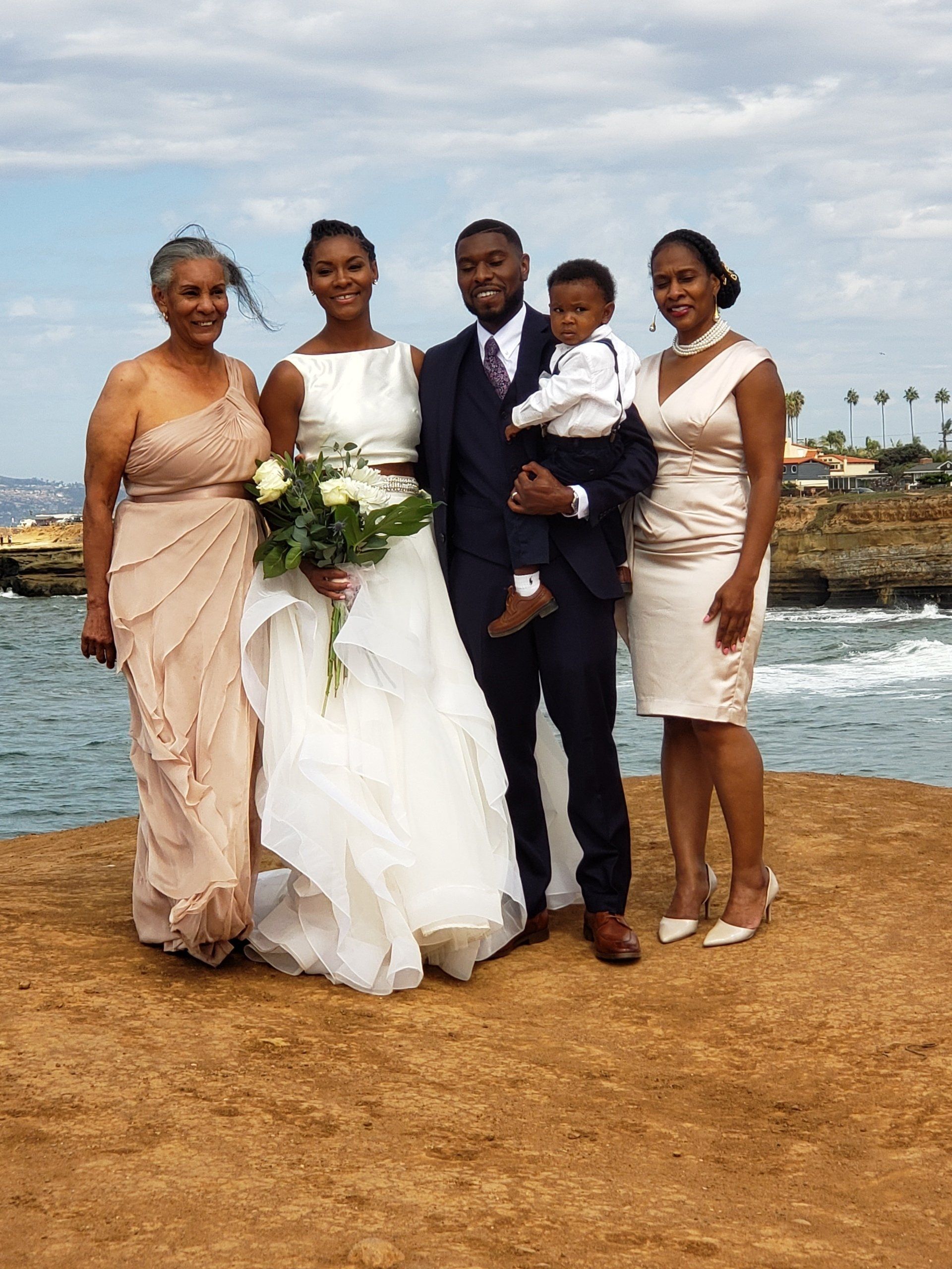 Sunset Cliffs in San Diego provides this backdrop for this after ceremony family photo with Bride, Groom and guests.