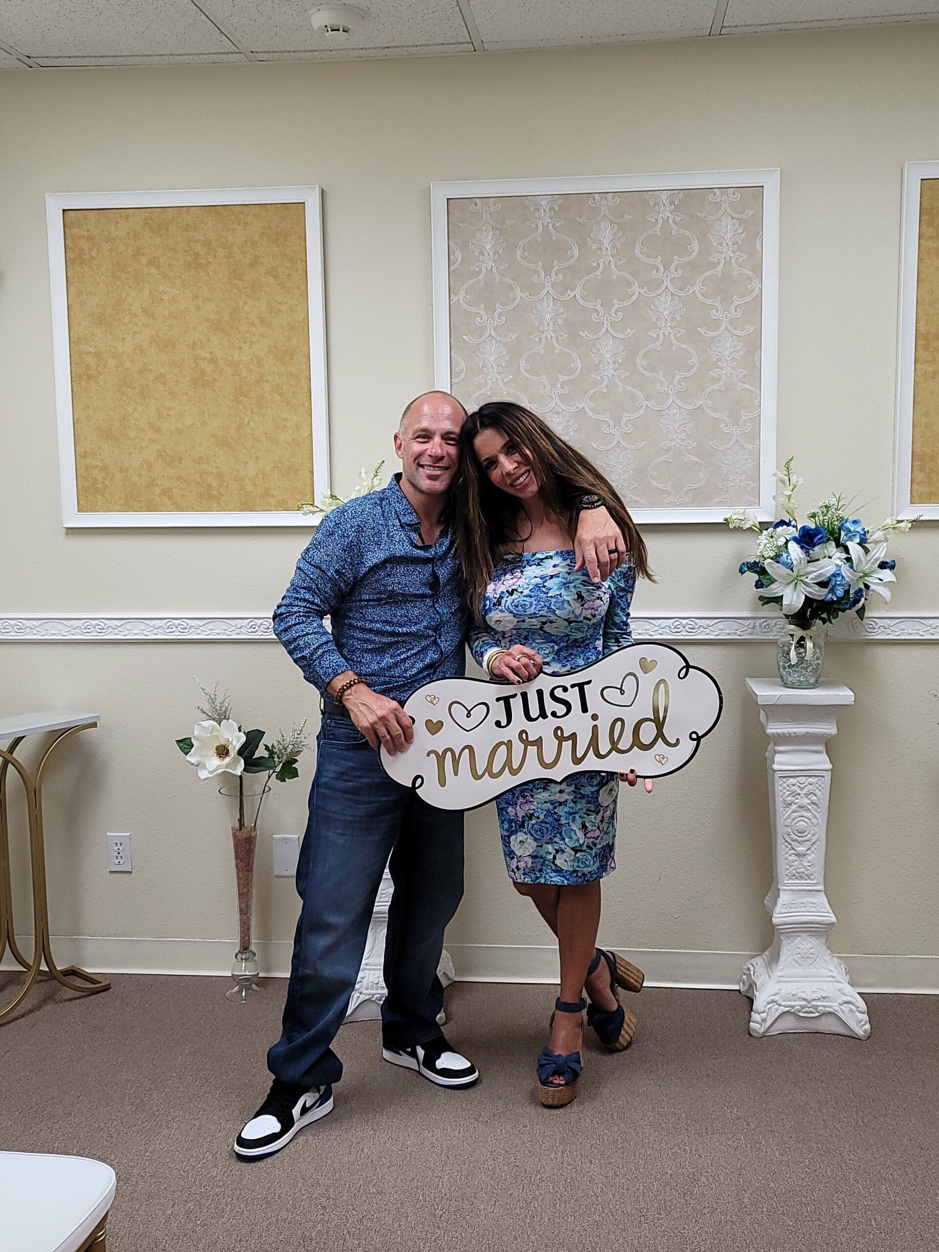 Happy couple celebrated with an embrace a Just Married sign at the Elopement Chapel in Rancho Mirage, CA