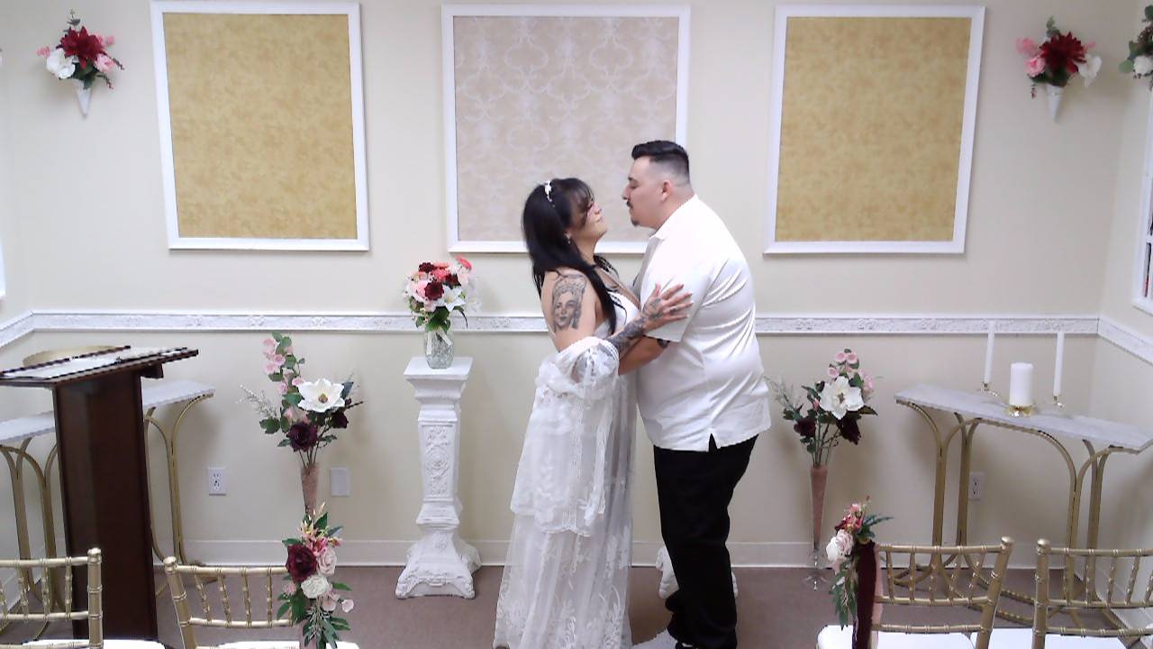 Couple in white prepare to exchange a wedding kiss at the Elopement Chapel in Rancho Mirage, CA