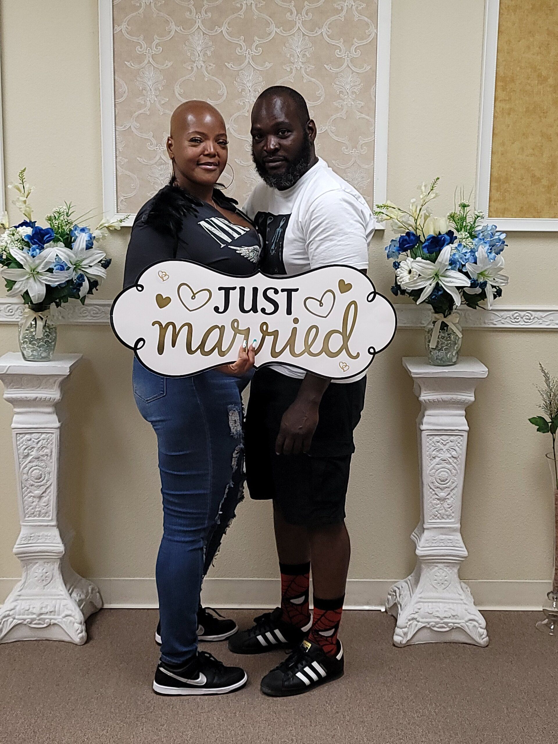 Couple poses for a photo and holds a Just Married sign after their Ceremony on Rancho Mirage, CA