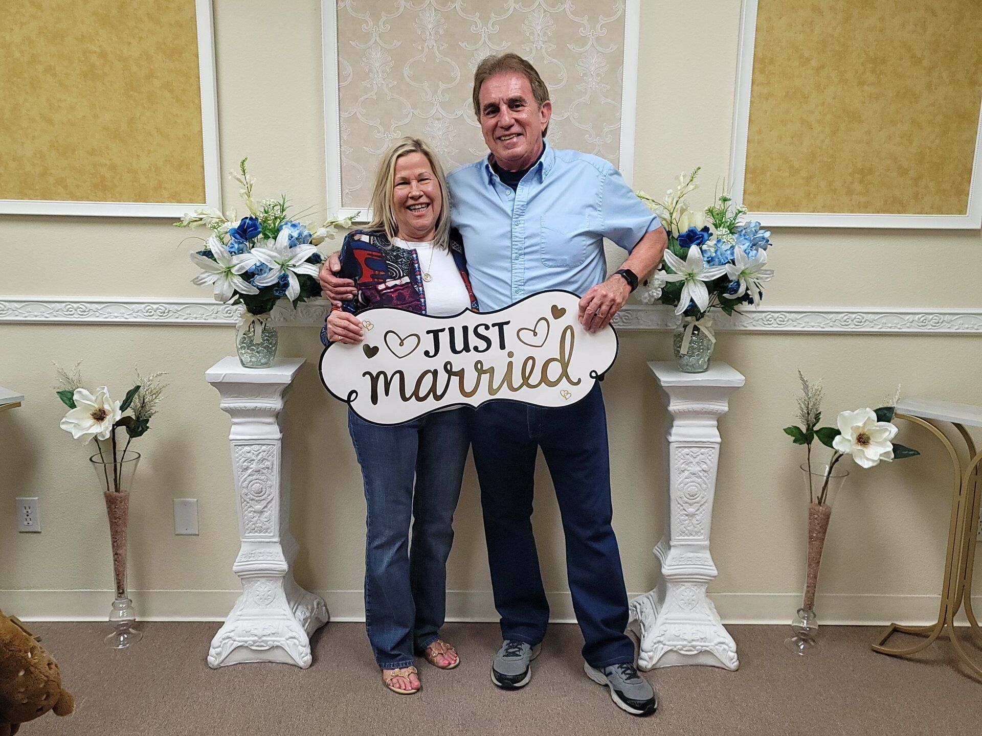 Couple holds Just Married sign smiles after their Elopement Ceremony on Rancho Mirage, CA