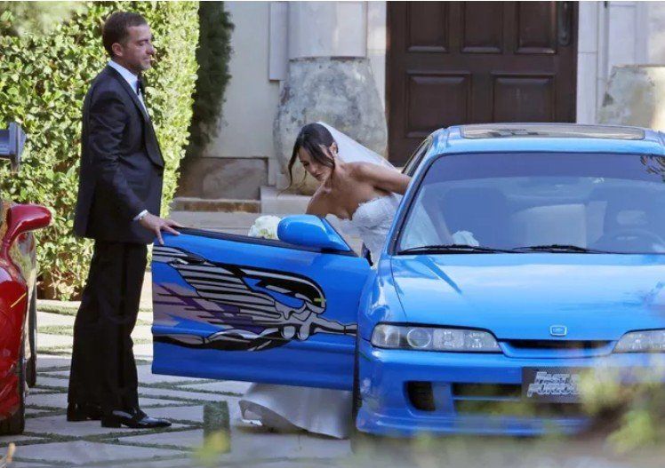 Jordana Brewster coming out of the wedding car