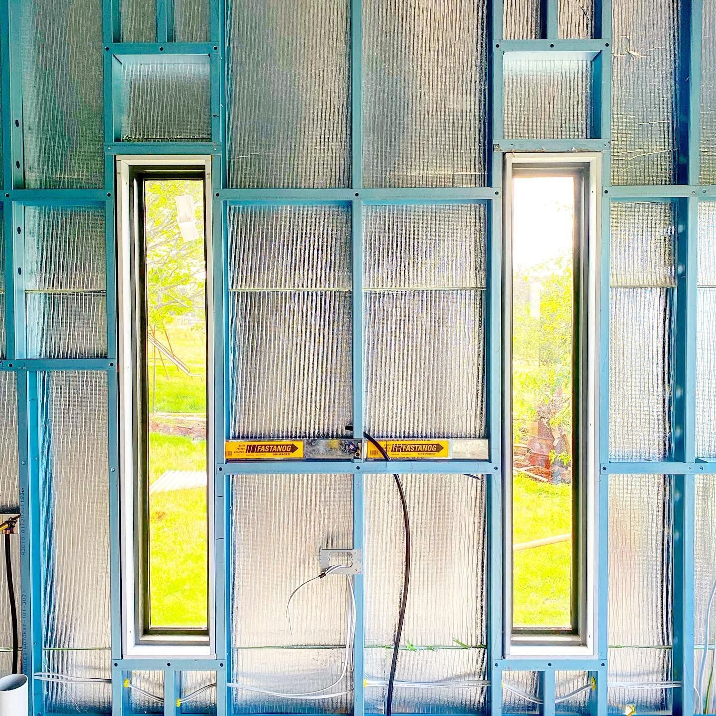There Are Two Windows in the Wall of a Building Under Construction — Steel Frame Company In Mudgee, NSW