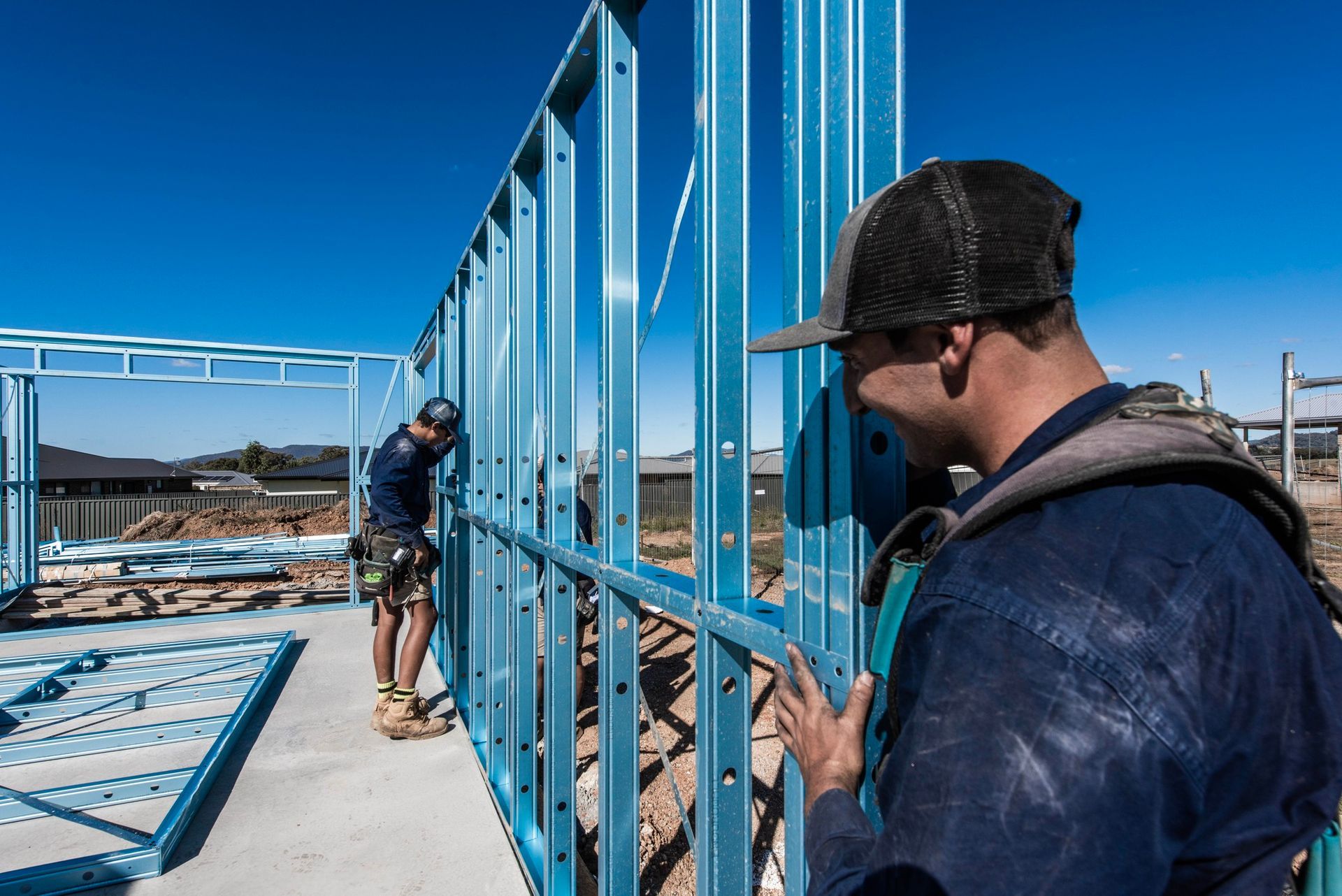 Two Men Are Working on a Building on a Construction Site — Steel Frame Company In Mudgee, NSW