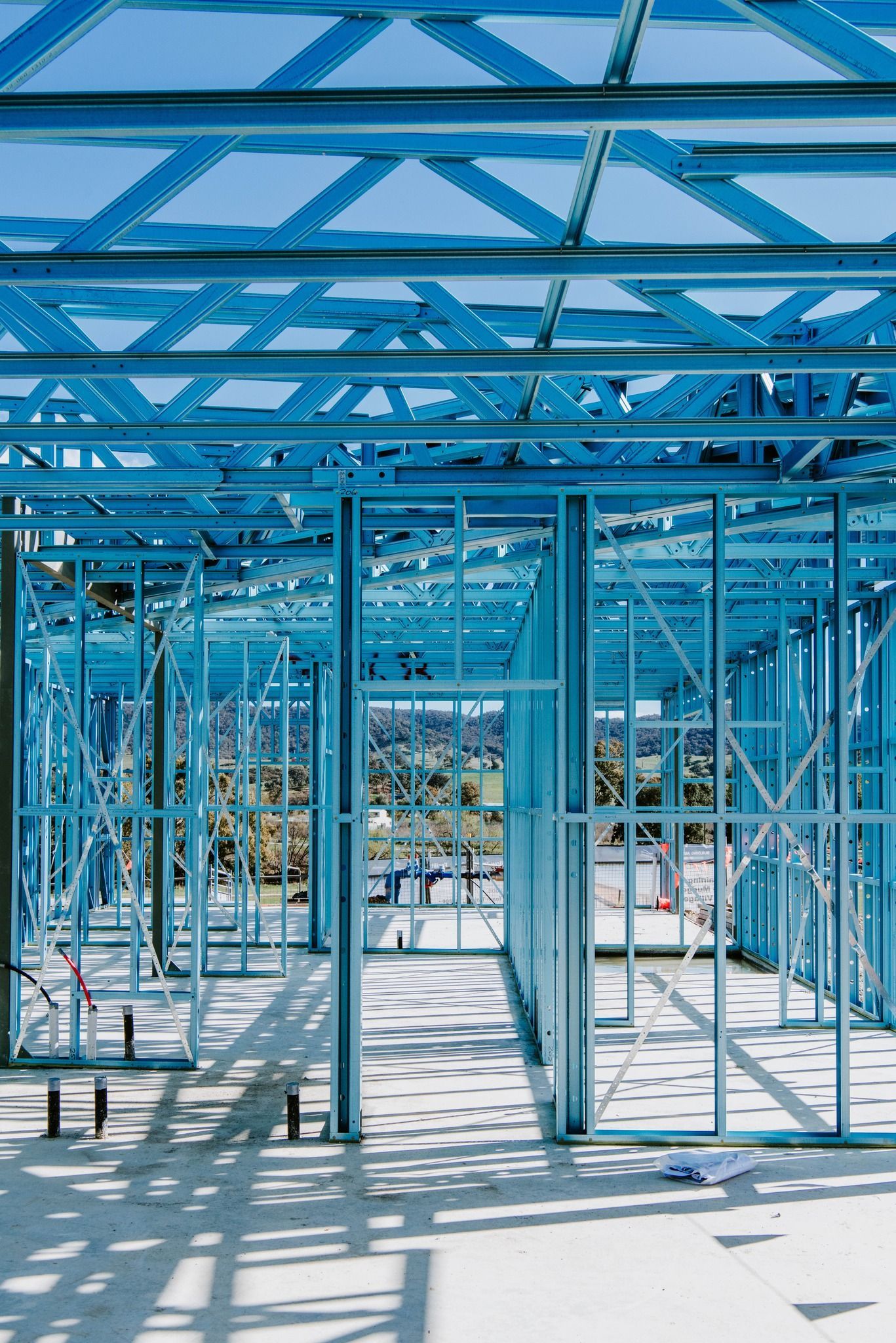 The Inside of a Building Under Construction With Blue Steel Frames — Steel Frame Company In Mudgee, NSW