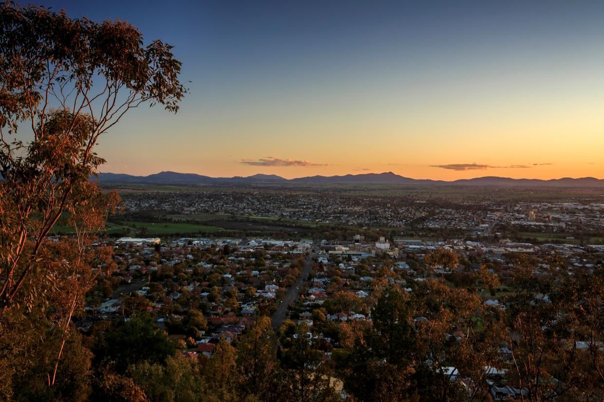 A Sunset Over a City With Mountains in the Background — Steel Frame Company In Tamworth, NSW