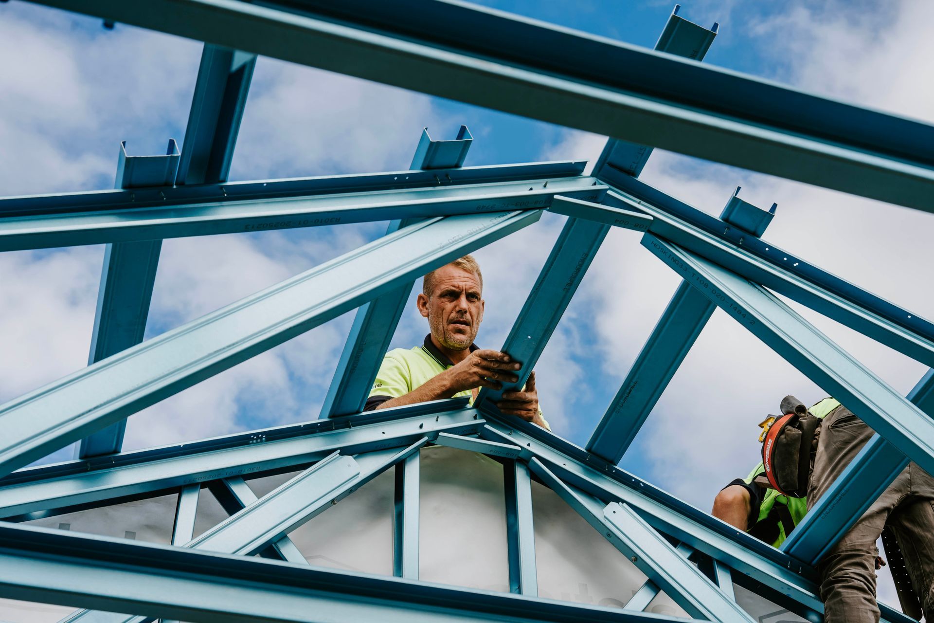 Two Men Are Working on a Metal Structure in a Factory — Steel Frame Company In Mudgee, NSW