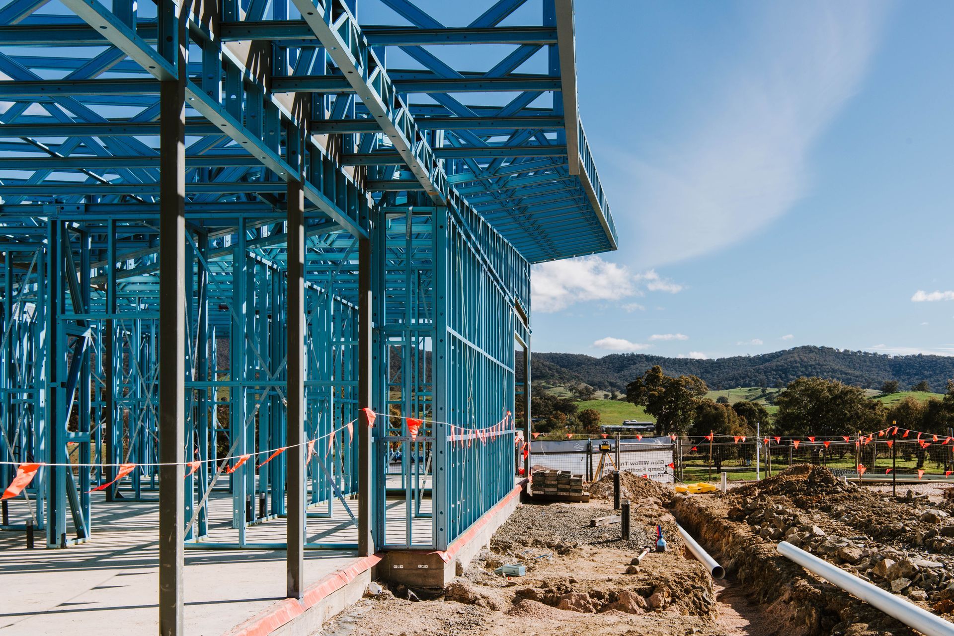 An aerial view of a residential area with cars parked on the side of the road.