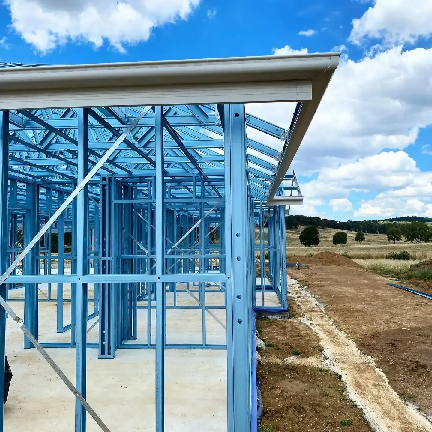 A Building Under Construction With a Blue Sky in the Background — Steel Frame Company In Mudgee, NSW
