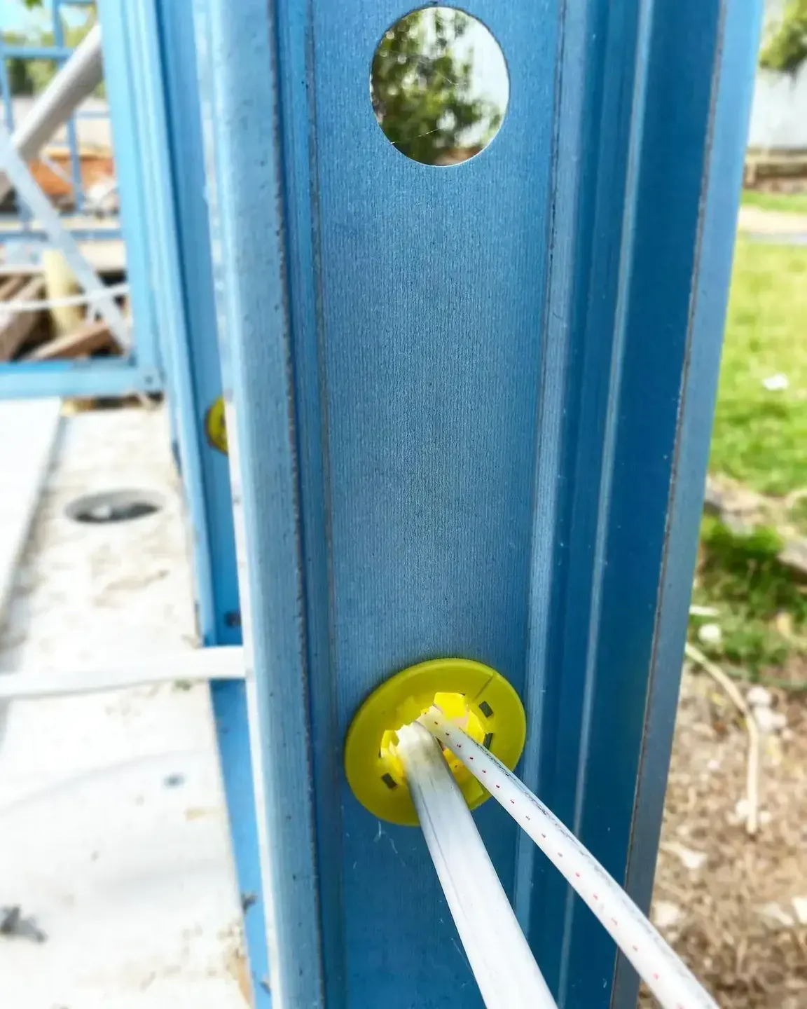 A Close Up of a Blue Metal Structure With Two Wires Coming Out of It — Steel Frame Company In Mudgee, NSW