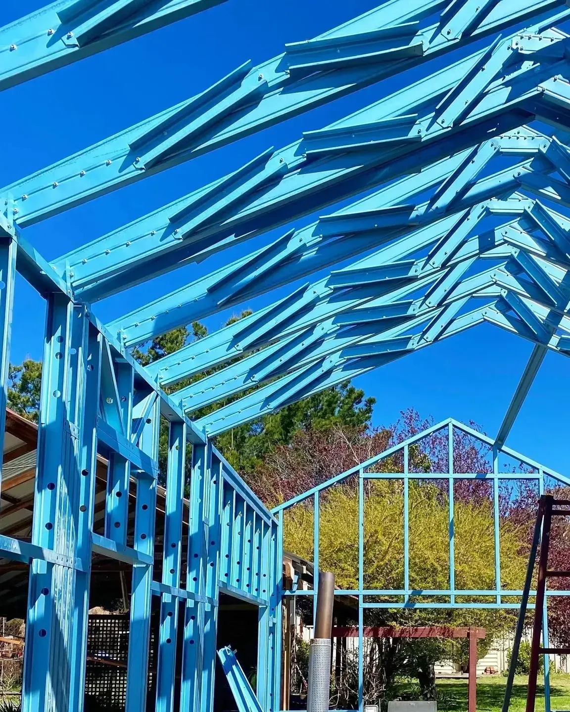 A Blue Building Under Construction With a Blue Sky in the Background — Steel Frame Company In Mudgee, NSW