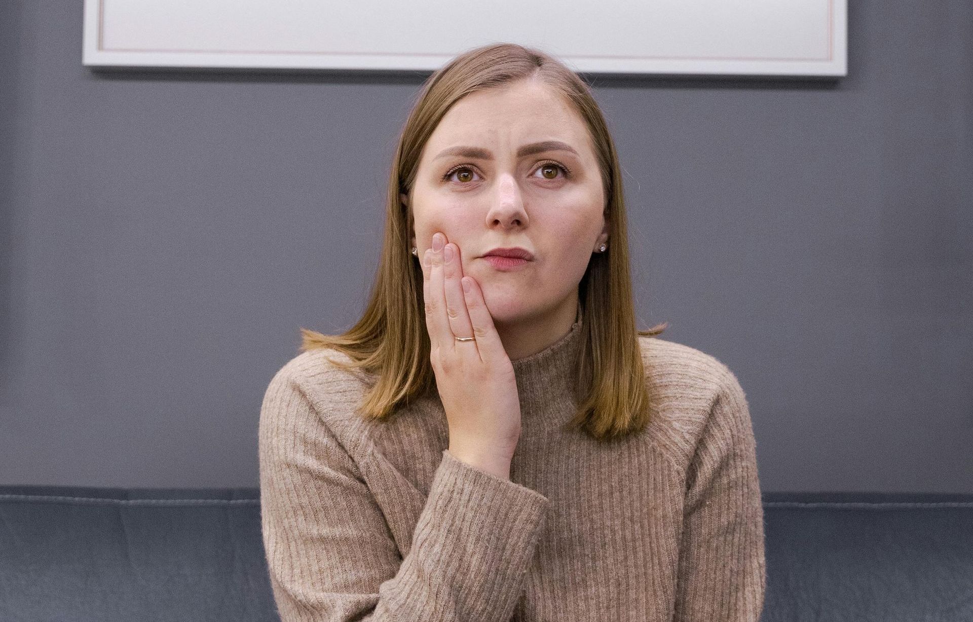 Woman smiling pain-free after a root canal | Get a root canal in Davenport, FL.