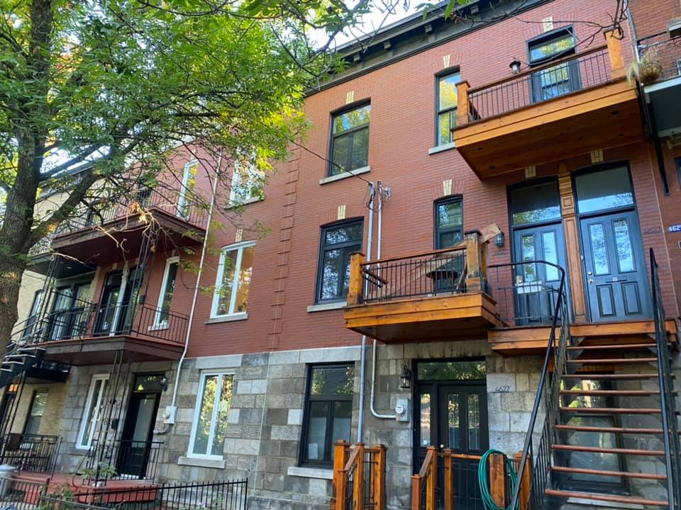 Un grand bâtiment en brique avec des escaliers menant au deuxième étage.