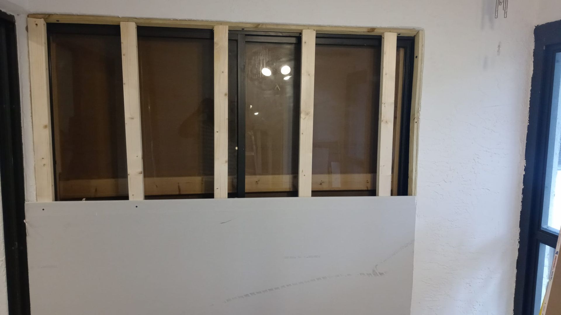 A kitchen with white cabinets , stainless steel appliances , and a large island.