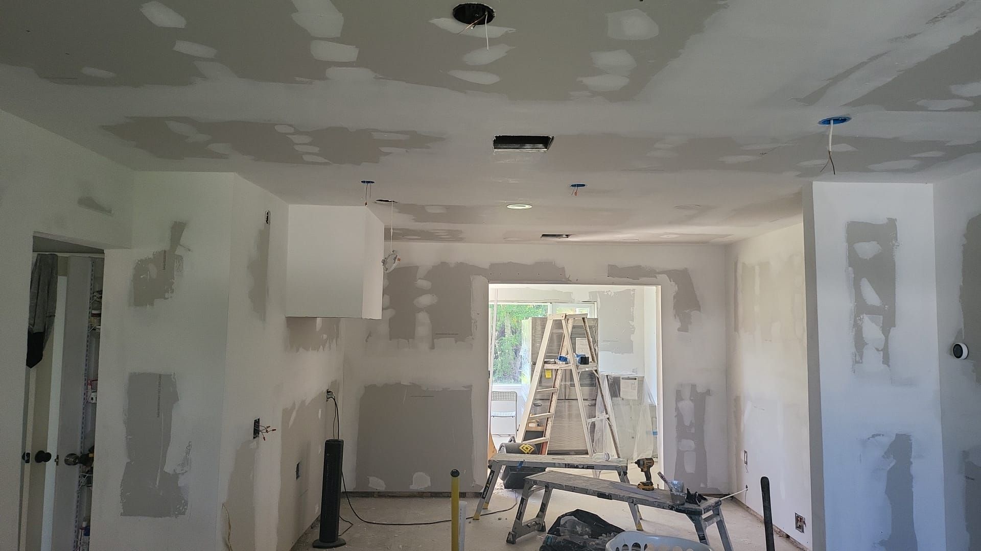 A man is using a drill to drill a hole in a piece of wood.