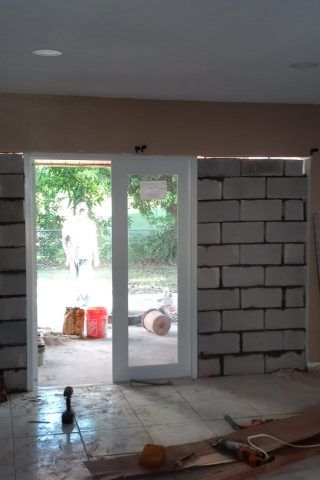A room with a brick wall and a sliding glass door