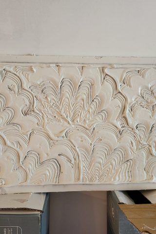 A white wall with a pattern on it is sitting on top of a table.