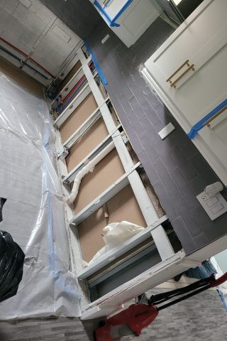 A kitchen is being remodeled with a lot of cabinets and drawers.