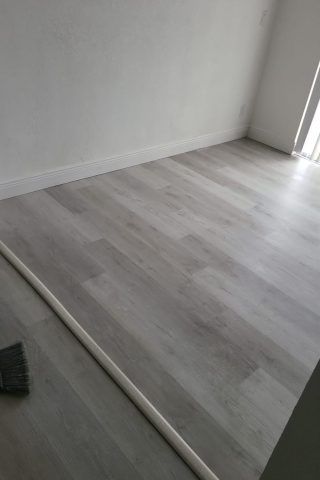 A room with a wooden floor and white walls.