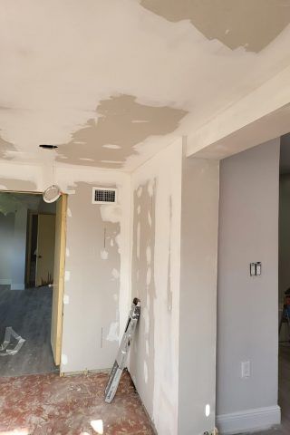 A room with a ladder leaning against the wall.