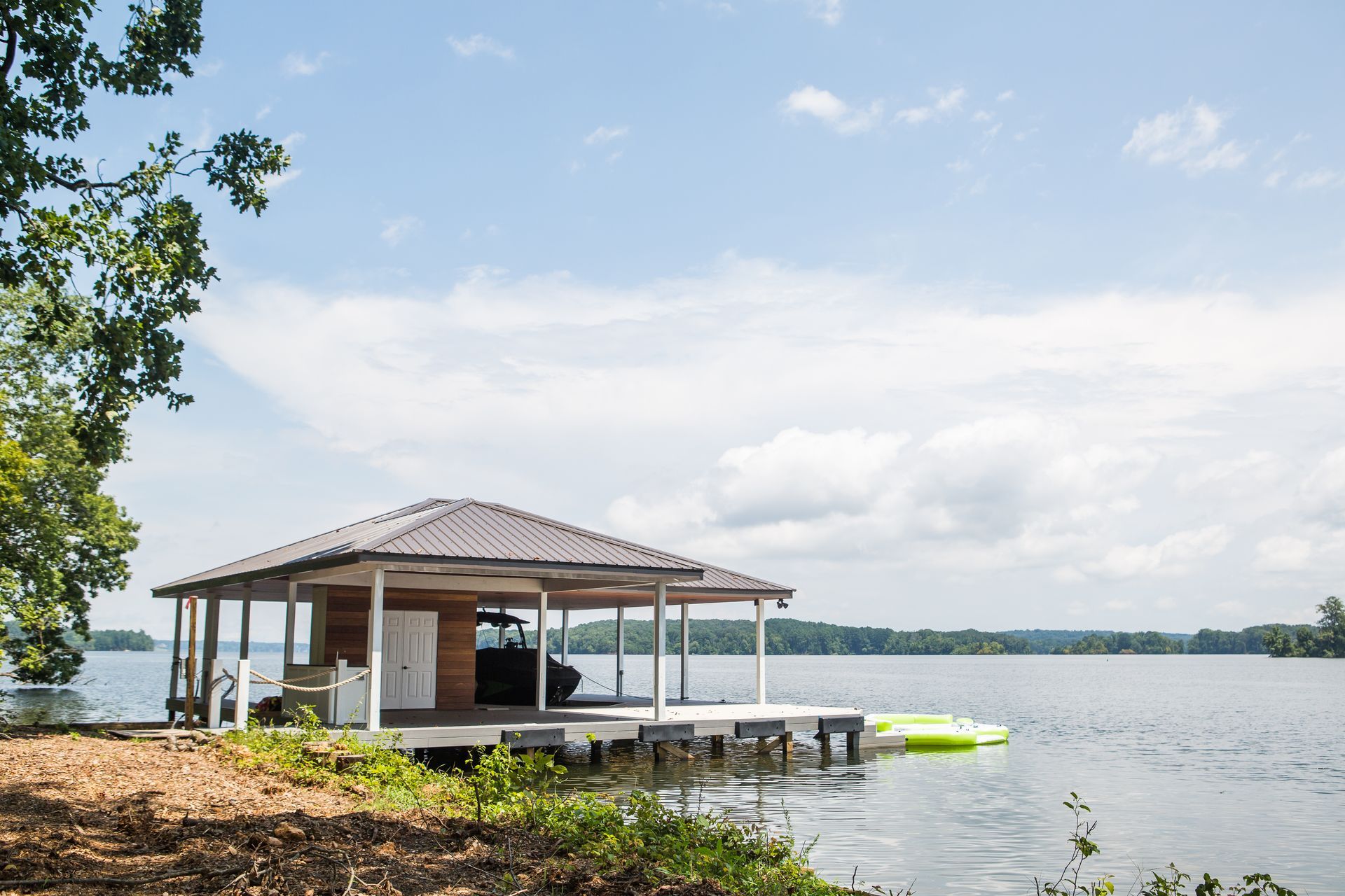 A small house on a dock overlooking a lake