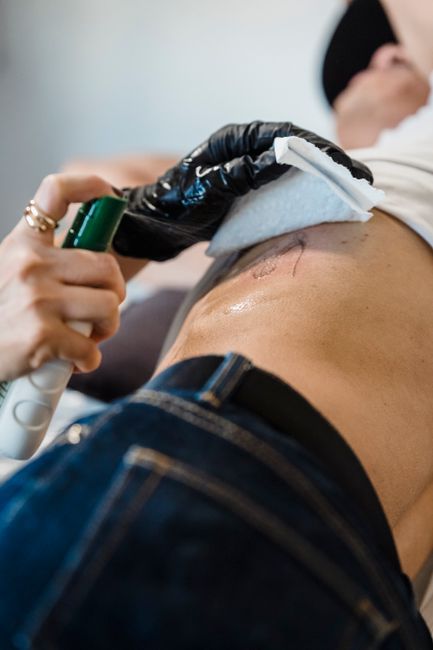 Person applying moisturiser to a new tattoo as part of the aftercare routine