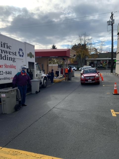A pacific west shredding truck is parked in a parking lot