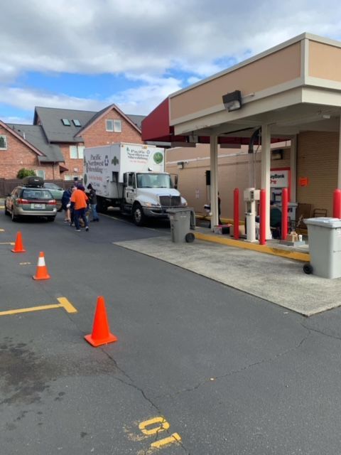 A white truck is parked in front of a building that says b1