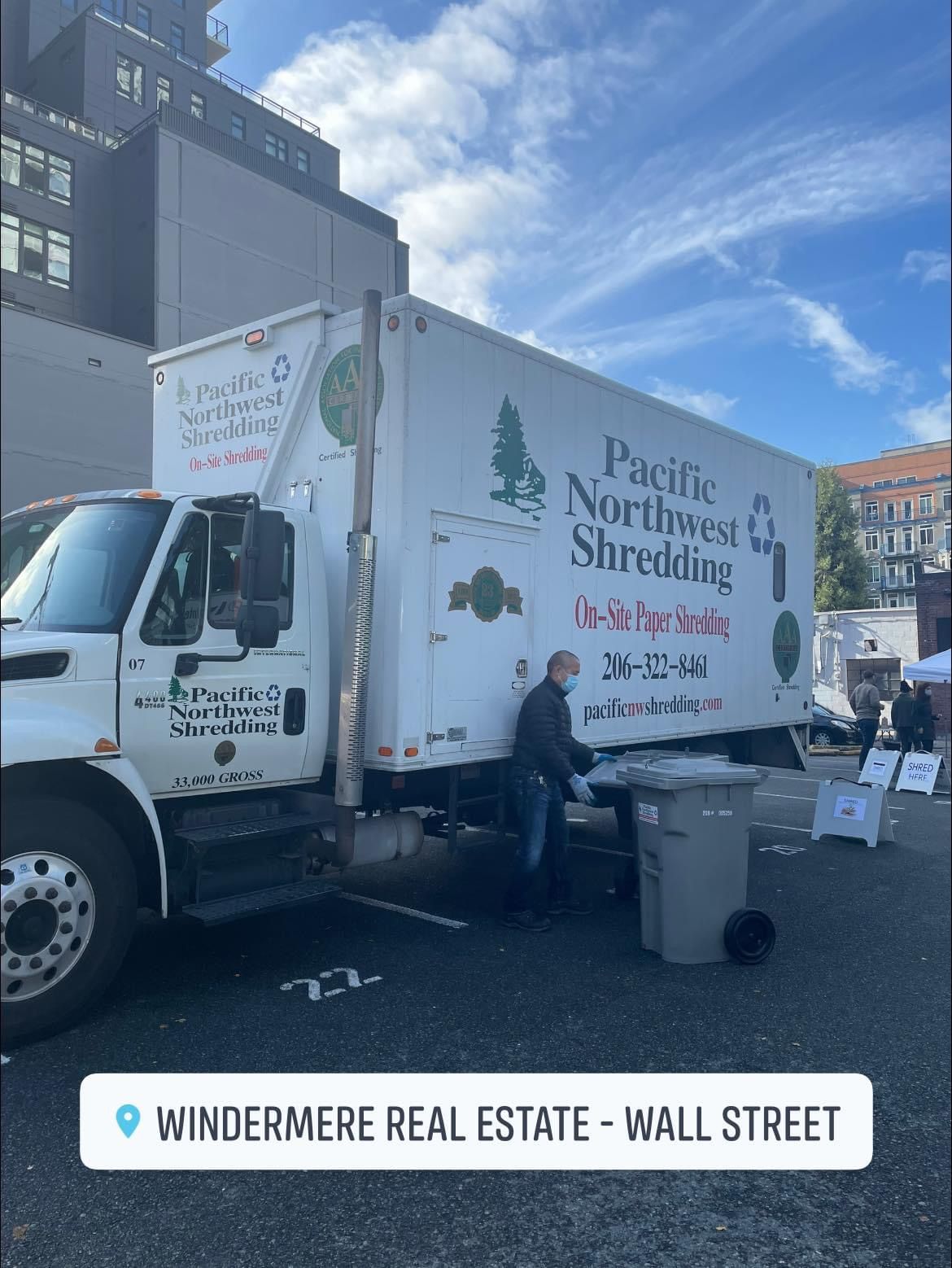 A pacific northwest shredding truck is parked in a parking lot.