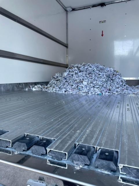 A pile of shredded paper in the back of a truck