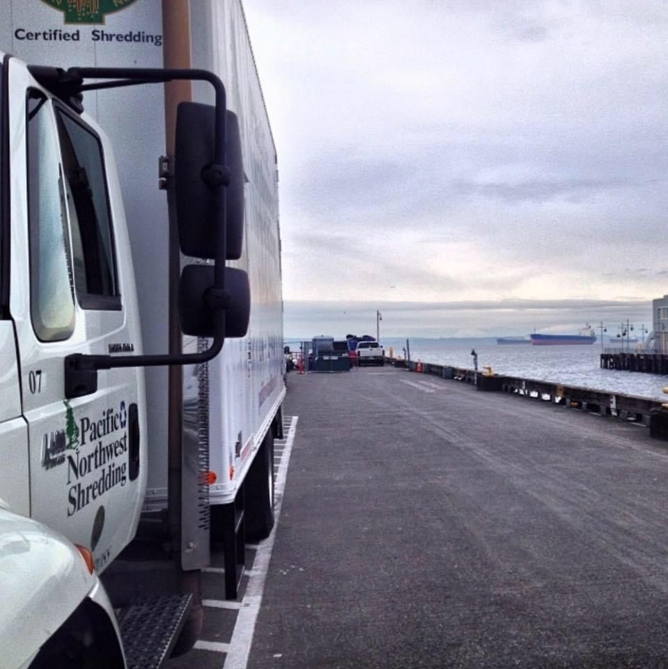 A certified shredding truck is parked on the side of the road
