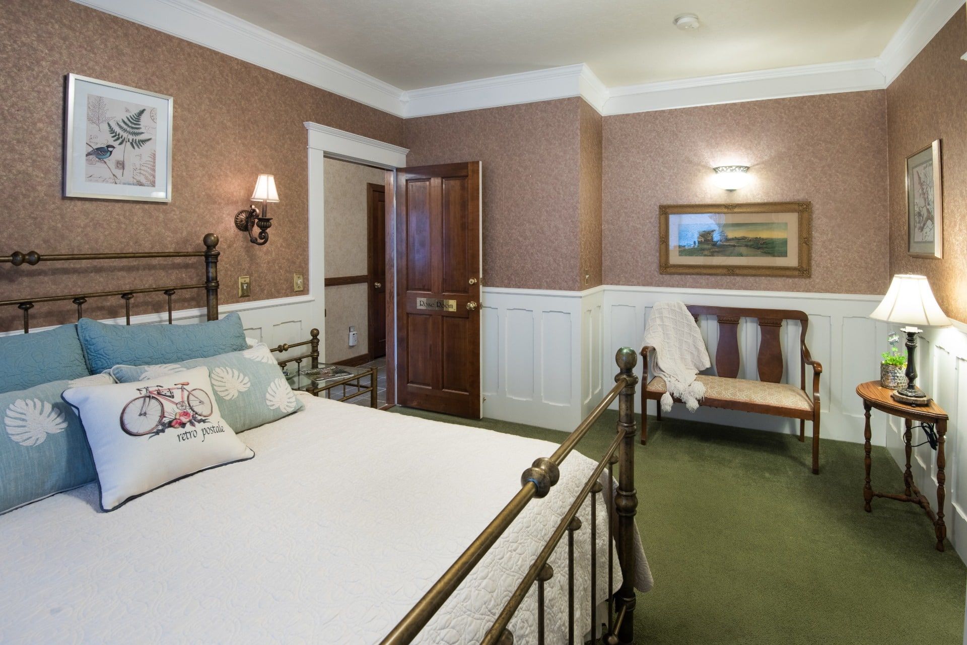 A bedroom with a king size bed and a bench